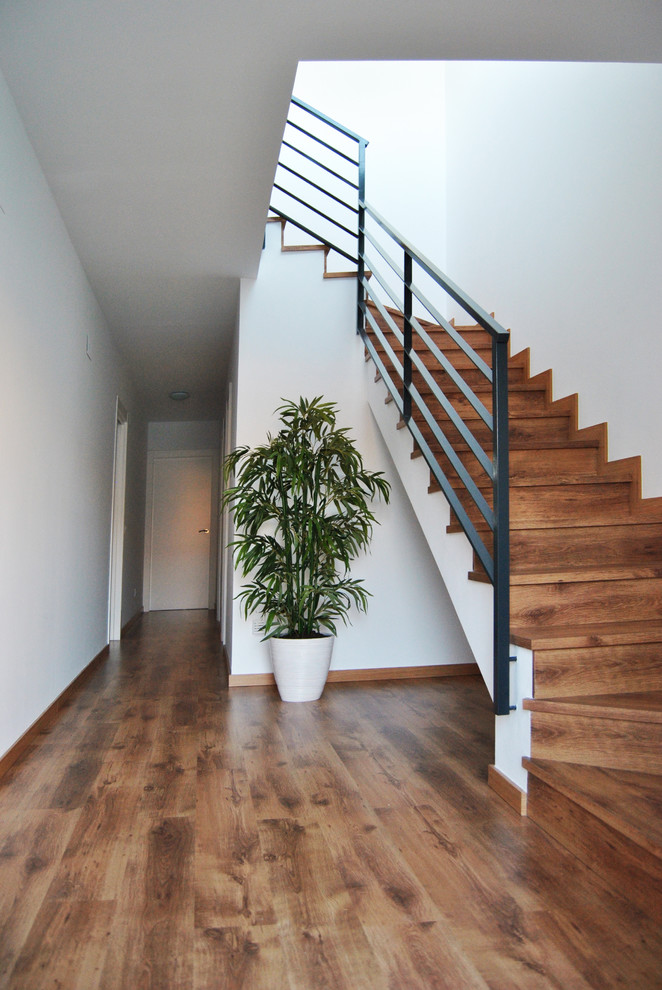 Inspiration for a small contemporary wood l-shaped staircase in Malaga with wood risers.