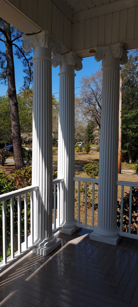 Design ideas for a large victorian front wood railing veranda in Raleigh with with columns, decking and a roof extension.