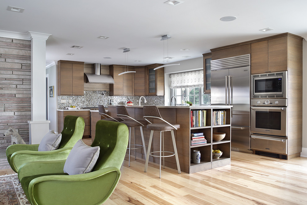 Design ideas for a midcentury l-shaped kitchen in New York with flat-panel cabinets, dark wood cabinets, grey splashback, mosaic tile splashback, stainless steel appliances, light hardwood floors, with island, beige floor and beige benchtop.