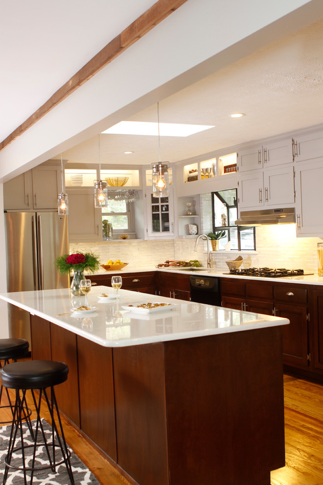 Mid-sized transitional u-shaped light wood floor enclosed kitchen photo in Atlanta with an undermount sink, recessed-panel cabinets, dark wood cabinets, quartz countertops, white backsplash, stone tile backsplash, stainless steel appliances and an island