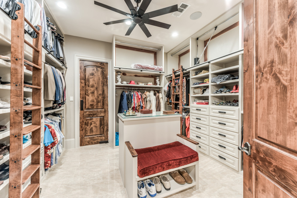 Inspiration for a traditional walk-in wardrobe in Houston with open cabinets, beige cabinets and beige floor.