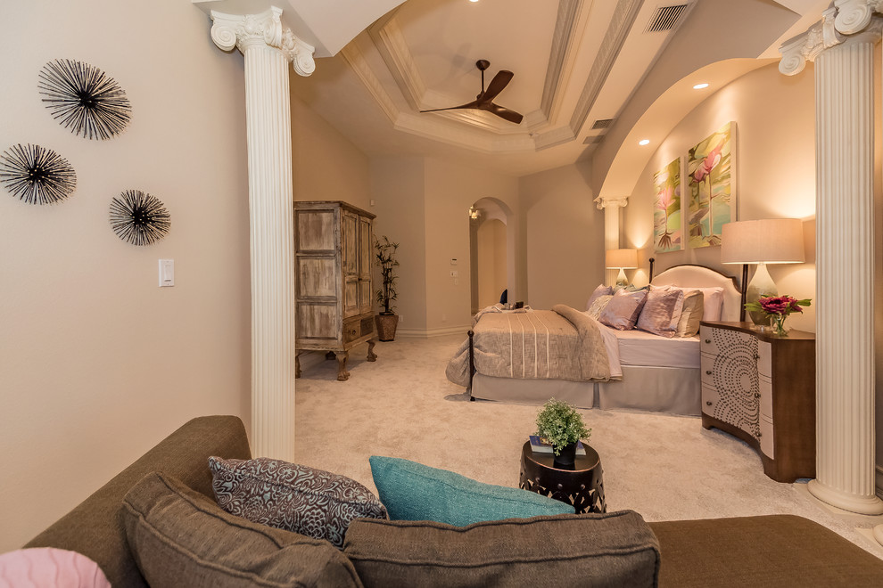 Expansive traditional master bedroom in Tampa with beige walls, carpet and beige floor.