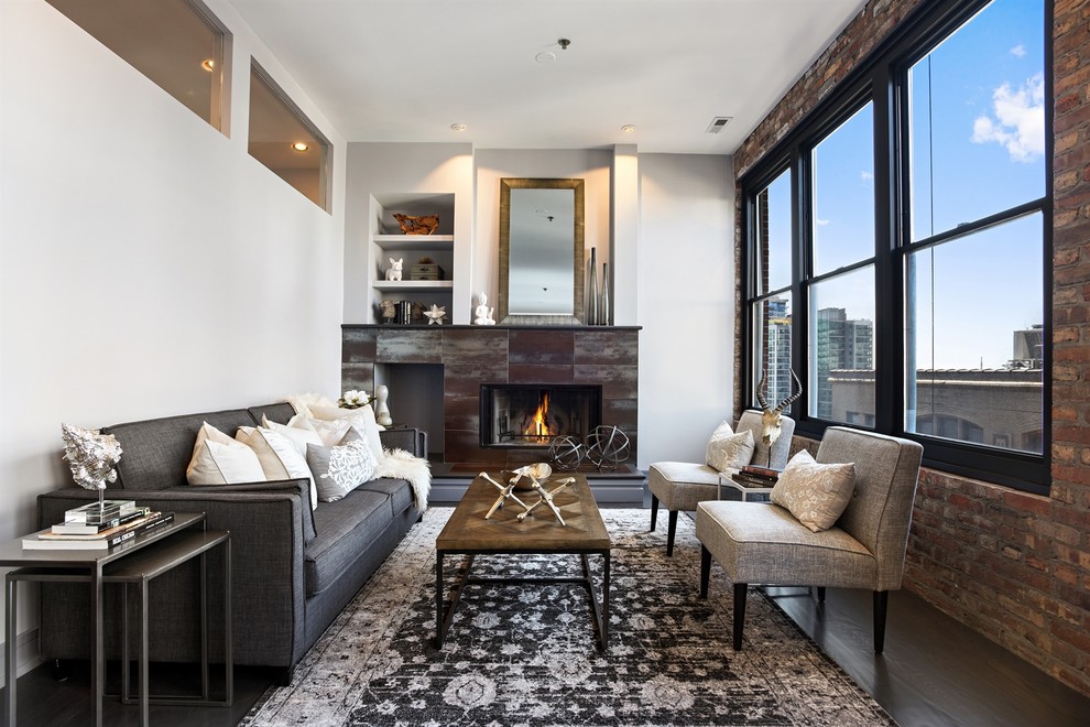 Industrial formal living room in Chicago with white walls, dark hardwood floors, no tv and a standard fireplace.
