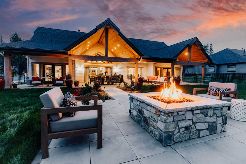 Inspiration for a large contemporary back patio in Other with a fire feature and concrete paving.