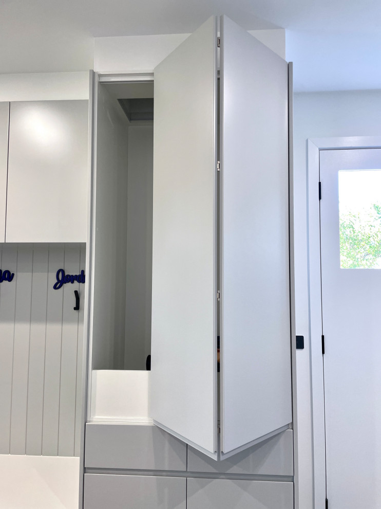 Expansive modern u-shaped dedicated laundry room in Sydney with an undermount sink, flat-panel cabinets, grey cabinets, quartz benchtops, white splashback, ceramic splashback, white walls, ceramic floors, a side-by-side washer and dryer, grey floor and white benchtop.