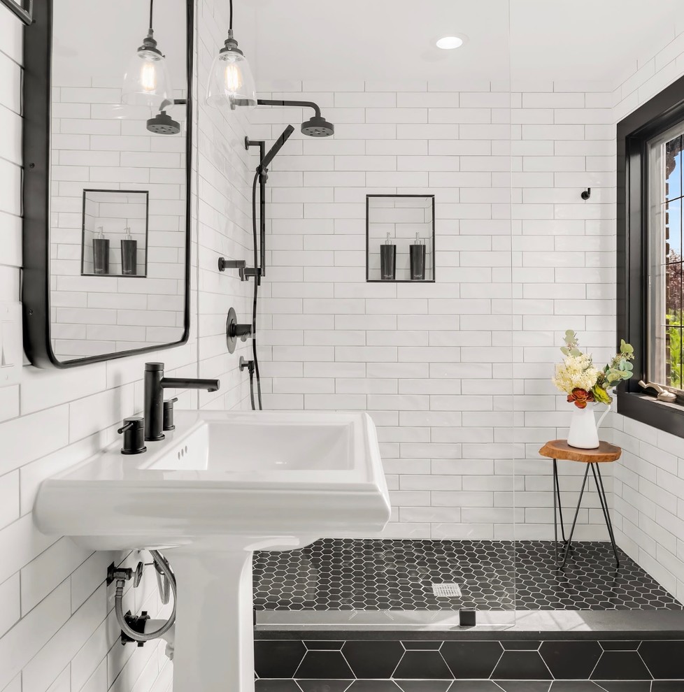 Photo of a small transitional 3/4 bathroom in Seattle with an open shower, white tile, ceramic floors, a pedestal sink, black floor, an open shower, subway tile and white walls.