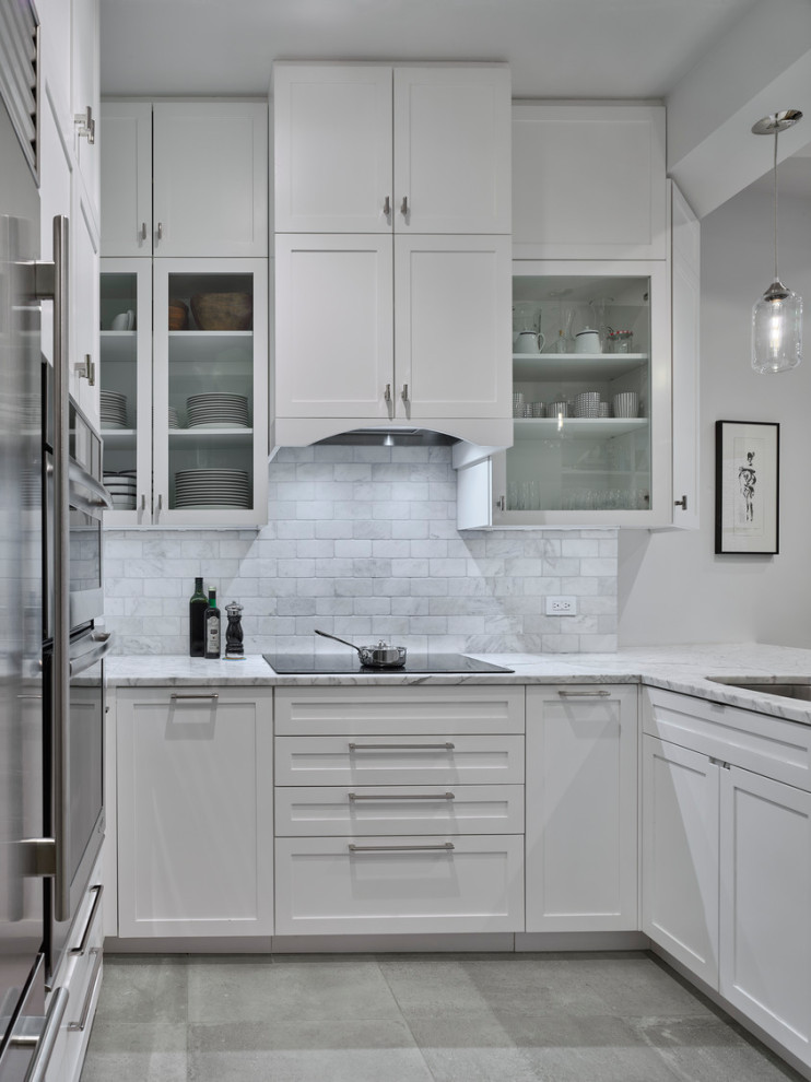 Design ideas for a small transitional u-shaped open plan kitchen in New York with an undermount sink, shaker cabinets, white cabinets, marble benchtops, grey splashback, marble splashback, stainless steel appliances, medium hardwood floors, a peninsula, brown floor and grey benchtop.
