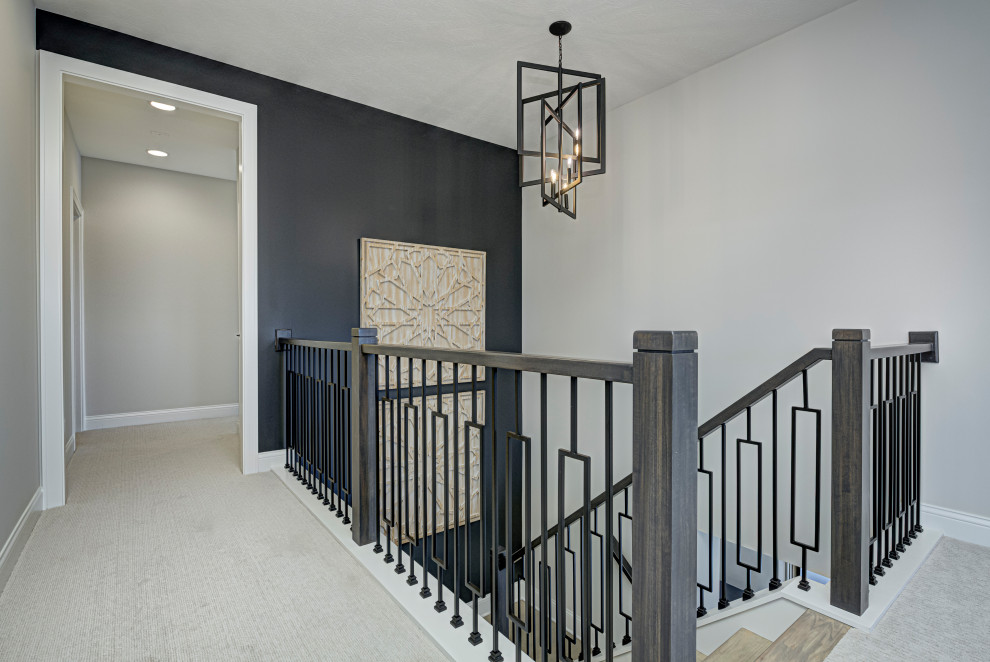 Design ideas for a mid-sized country wood u-shaped staircase in Indianapolis with concrete risers and wood railing.