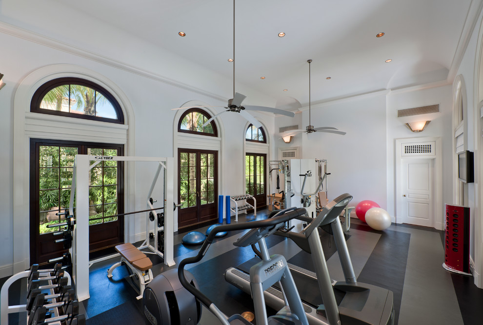 Photo of a large traditional home weight room in Miami with white walls, vinyl floors and multi-coloured floor.