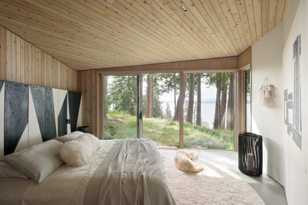 Réalisation d'une chambre parentale chalet en bois de taille moyenne avec sol en béton ciré, aucune cheminée, un sol gris et un plafond en bois.