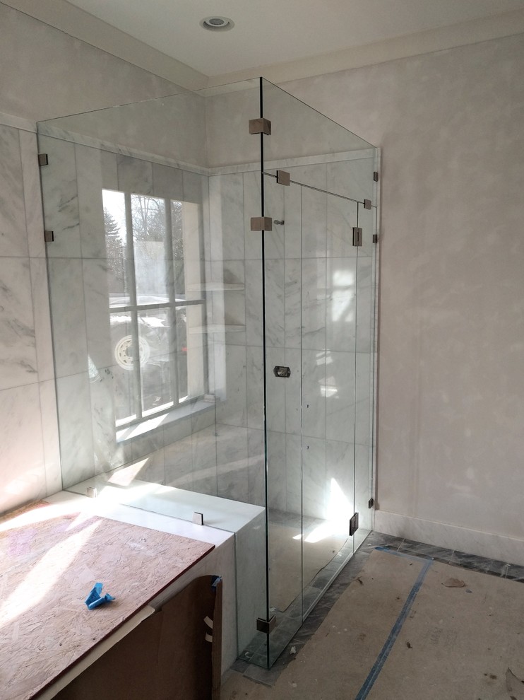 Transitional master corner shower photo with a hinged shower door