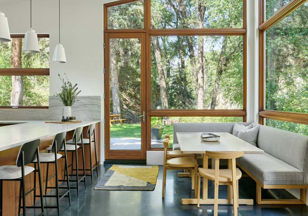 Inspiration pour une salle à manger design avec une banquette d'angle, un mur blanc, sol en béton ciré et un sol bleu.