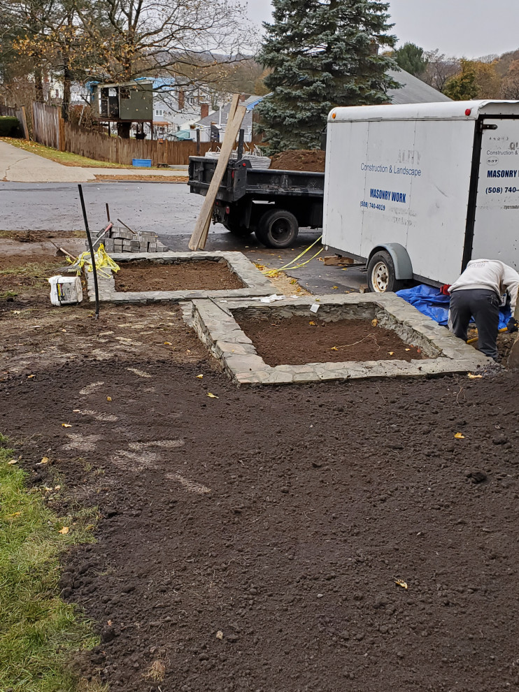 Photo of a mid-sized contemporary front yard full sun formal garden for spring in Boston with with flowerbed and natural stone pavers.