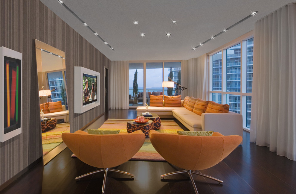 This is an example of a large contemporary living room in Miami with a wall-mounted tv.