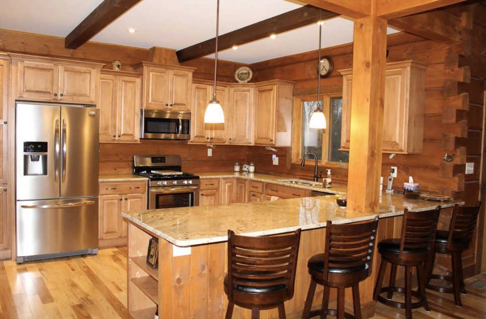 Inspiration for a large rustic galley dark wood floor open concept kitchen remodel in Boston with an undermount sink, shaker cabinets, white cabinets, granite countertops, stainless steel appliances and an island