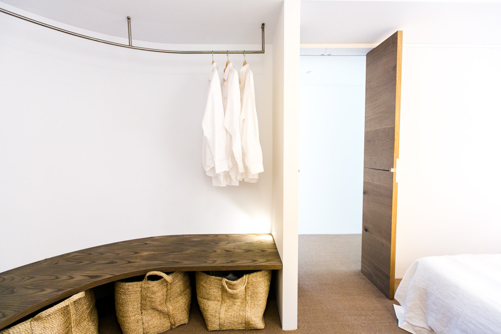 Inspiration for a contemporary gender-neutral storage and wardrobe in Sydney with open cabinets and carpet.