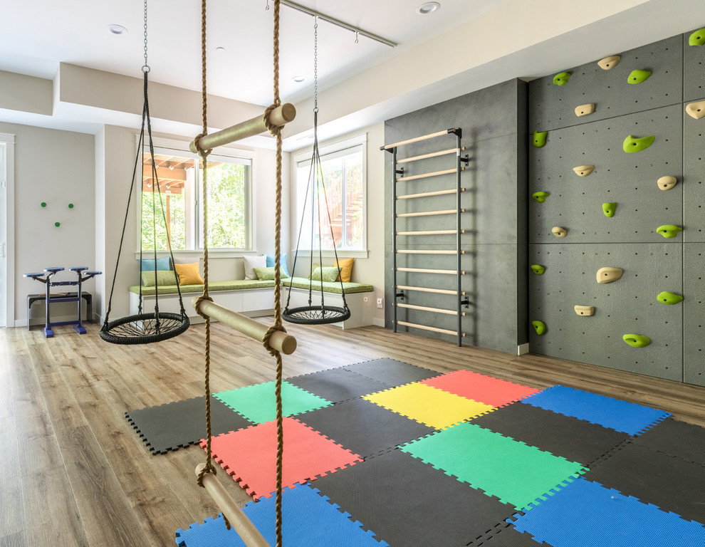 Family Headquarters Play Room - Having two young boys presents its own challenges, and when you have two of their best friends constantly visiting, you end up with four super active action heroes. This family wanted to dedicate a space for the boys to hangout. We took an ordinary basement and converted it into a playground heaven.  A basketball hoop, climbing ropes, swinging chairs, rock climbing wall, and climbing bars, provide ample opportunity for the boys to let their energy out, and the built-in window seat is the perfect spot to catch a break. Tall built-in wardrobes and drawers beneath the window seat to provide plenty of storage for all the toys. 

You can guess where all the neighborhood kids come to hangout now ☺