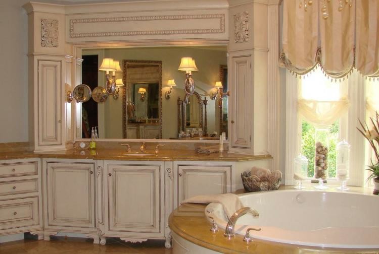 Example of a beige tile porcelain tile bathroom design with white cabinets, granite countertops and a hot tub