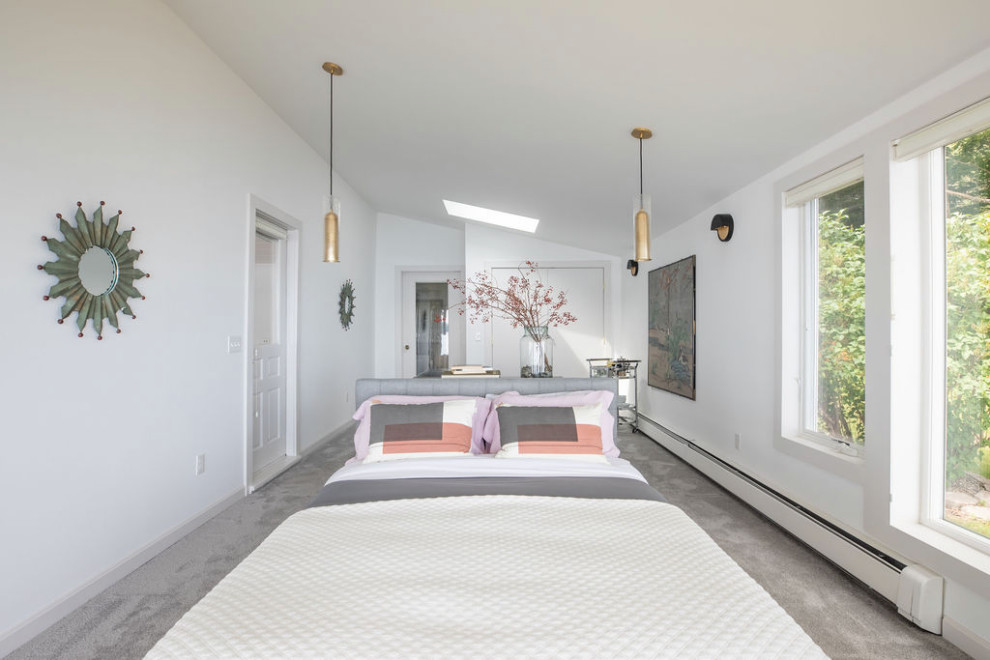 Inspiration for a modern master bedroom in Portland Maine with white walls, carpet and grey floors.