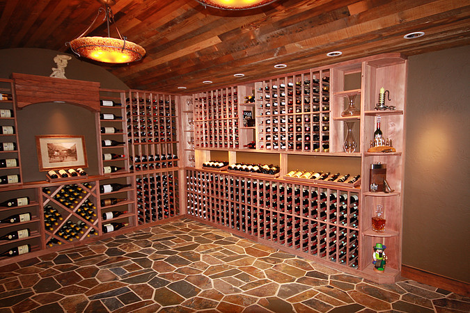 Mountain style wine cellar photo in Denver with storage racks