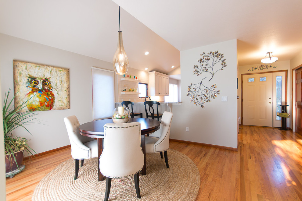 Kitchen/dining room combo - transitional light wood floor and brown floor kitchen/dining room combo idea with an undermount sink, shaker cabinets, white cabinets, quartz countertops, white backsplash, ceramic backsplash and stainless steel appliances