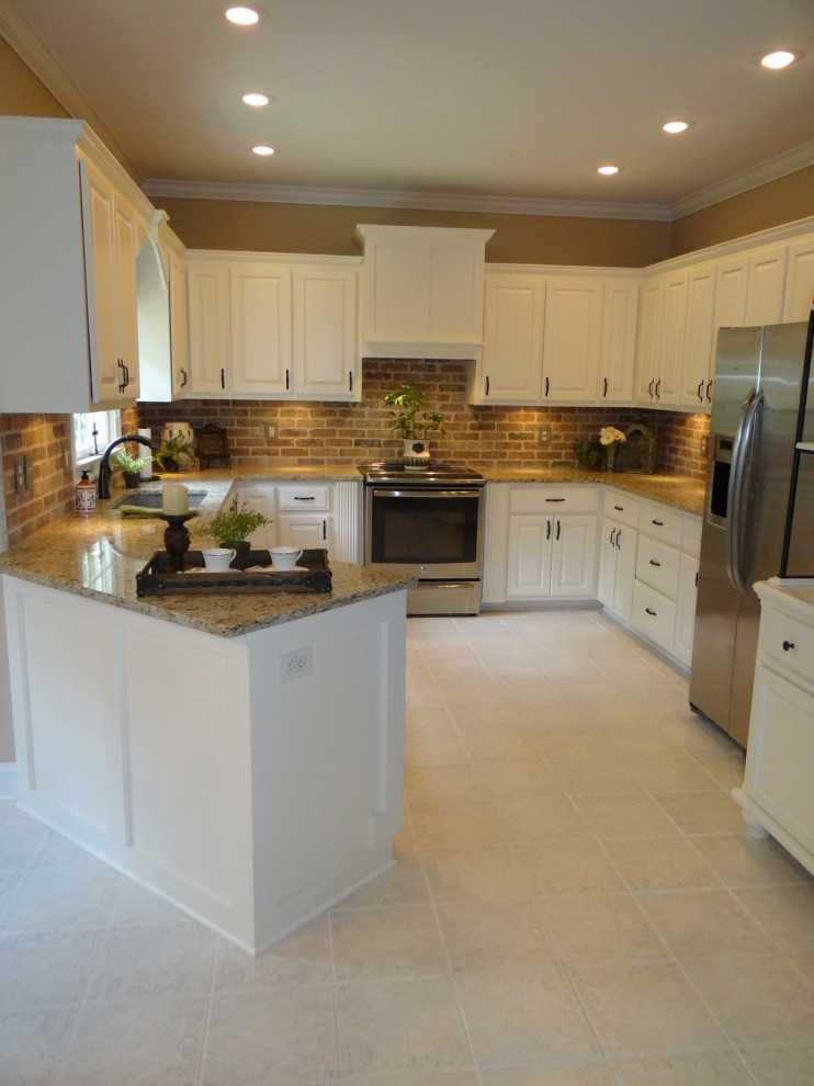 Photo of a mid-sized traditional u-shaped separate kitchen in Atlanta with an undermount sink, recessed-panel cabinets, white cabinets, granite benchtops, brown splashback, brick splashback, stainless steel appliances, linoleum floors, no island, beige floor and multi-coloured benchtop.