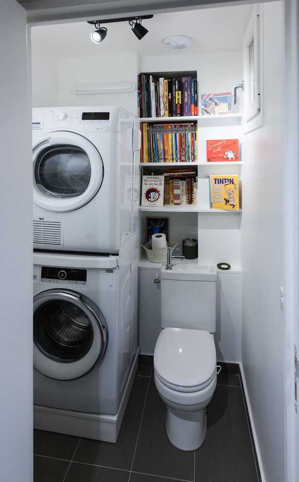 Design ideas for a small contemporary single-wall utility room in Other with open cabinets, white cabinets, white walls, ceramic floors and a stacked washer and dryer.