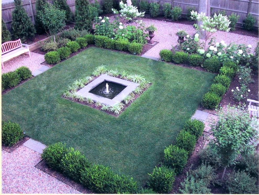 Inspiration for a traditional backyard partial sun formal garden in Providence with gravel.