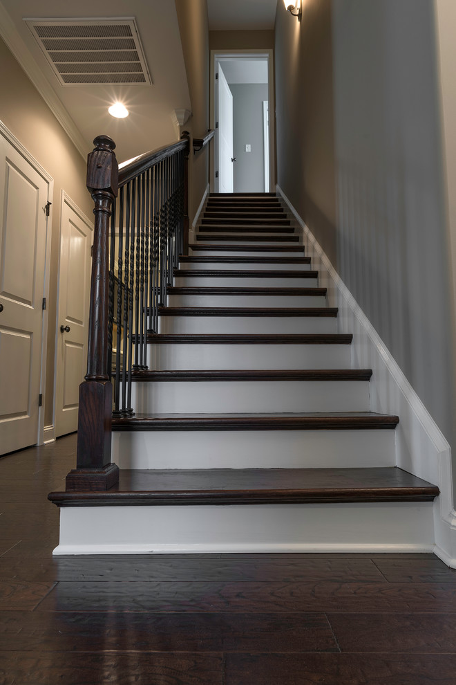 Example of a mid-sized transitional wooden straight staircase design with painted risers