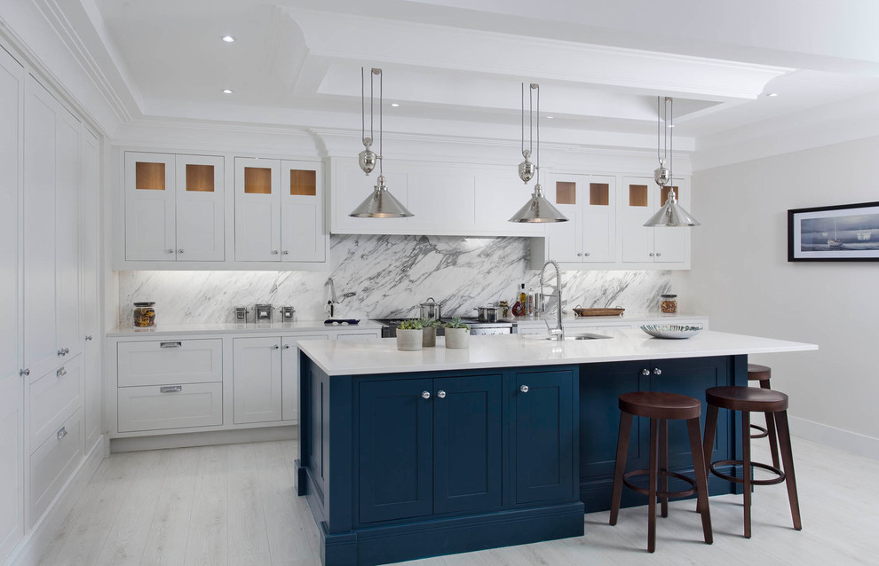 Inspiration for a mid-sized transitional l-shaped open plan kitchen in Other with an undermount sink, shaker cabinets, grey cabinets, quartzite benchtops, grey splashback, marble splashback, stainless steel appliances, light hardwood floors, with island and white floor.