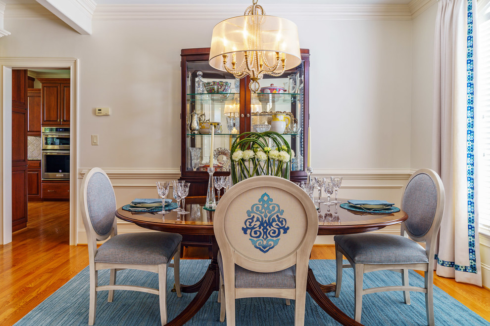 Mid-sized transitional medium tone wood floor and brown floor dining room photo with white walls and no fireplace