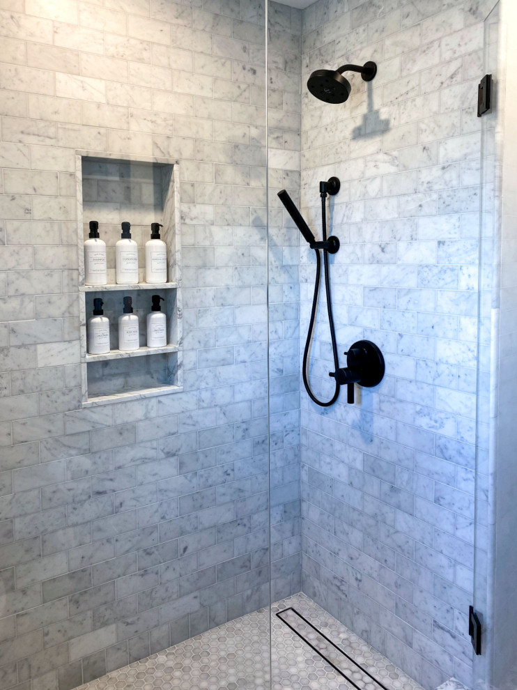 Mid-sized transitional master gray tile and marble tile porcelain tile, black floor and double-sink bathroom photo in Boston with shaker cabinets, gray cabinets, a two-piece toilet, gray walls, an undermount sink, marble countertops, a hinged shower door, gray countertops and a built-in vanity