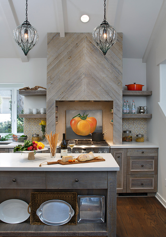 Inspiration for a beach style kitchen in Denver with recessed-panel cabinets, medium wood cabinets, multi-coloured splashback, stainless steel appliances, dark hardwood floors and with island.