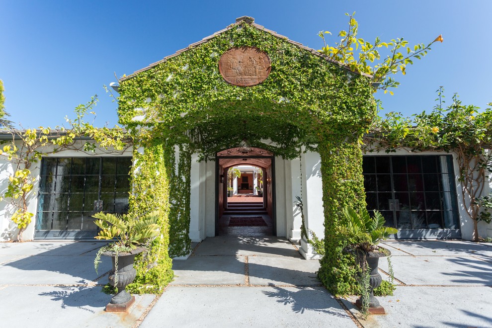 This is an example of a mediterranean entryway in Santa Barbara with white walls.