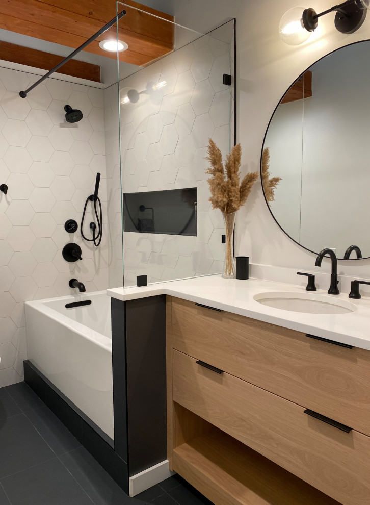 Small modern bathroom in Chicago with flat-panel cabinets, light wood cabinets, an alcove bath, a shower/bath combination, a one-piece toilet, white tiles, white walls, a submerged sink, quartz worktops, white worktops, a wall niche, a single sink, a built in vanity unit and exposed beams.