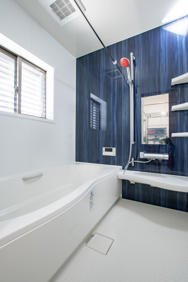 This is an example of a small contemporary master wet room bathroom in Other with a corner tub, multi-coloured walls, white floor and a hinged shower door.