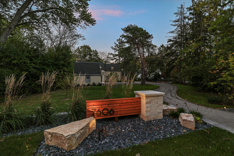 Photo of a mid-sized modern partial sun front yard stone and wood fence walkway in Milwaukee.