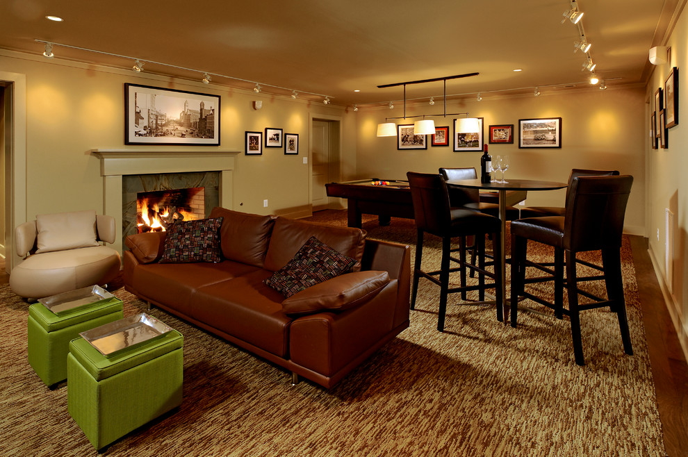Inspiration for a traditional fully buried basement in DC Metro with beige walls, dark hardwood floors, a standard fireplace, a stone fireplace surround and brown floor.