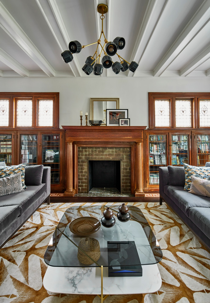 Medium sized bohemian enclosed living room in New York with white walls, dark hardwood flooring, a standard fireplace, a tiled fireplace surround, yellow floors and a coffered ceiling.