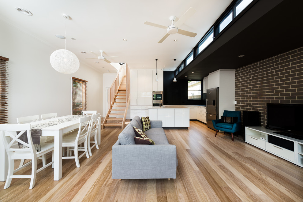 Photo of a mid-sized contemporary open concept living room in Melbourne with medium hardwood floors.