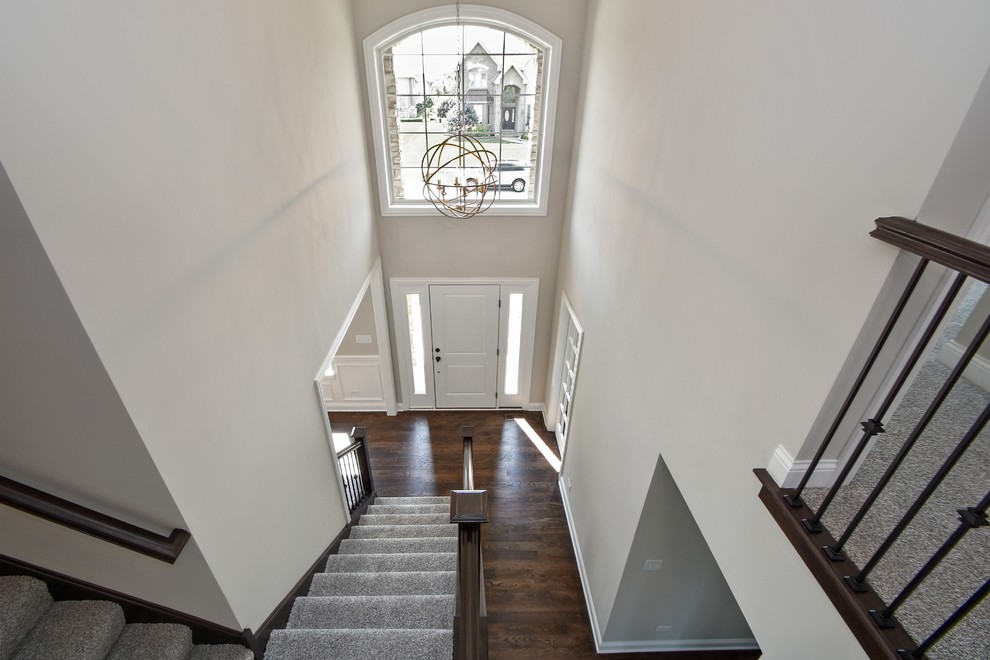 Staircase - mid-sized transitional carpeted l-shaped wood railing staircase idea in Chicago with carpeted risers