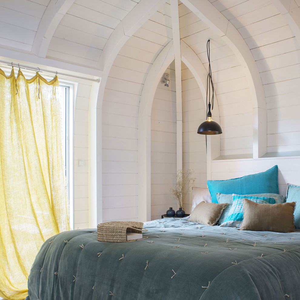 Photo of a beach style bedroom in Paris with white walls.