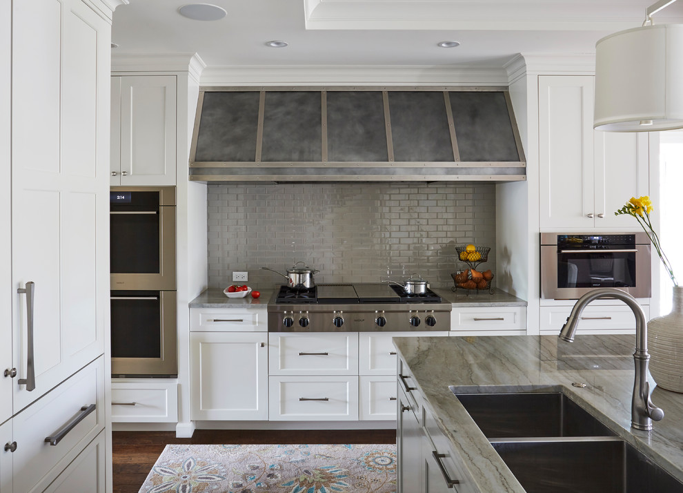 Eat-in kitchen - mid-sized transitional u-shaped dark wood floor eat-in kitchen idea with a double-bowl sink, raised-panel cabinets, white cabinets, marble countertops, gray backsplash, marble backsplash, stainless steel appliances and an island
