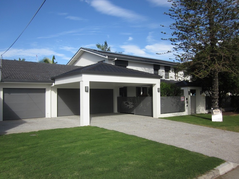 Large modern two-storey brick white house exterior in Gold Coast - Tweed with a gable roof and a tile roof.