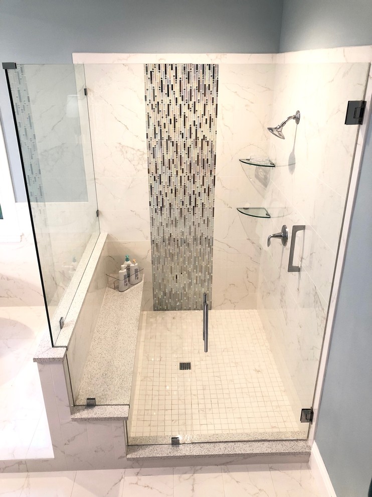 Inspiration for a large transitional master bathroom in Tampa with raised-panel cabinets, light wood cabinets, a freestanding tub, a corner shower, a one-piece toilet, multi-coloured tile, blue walls, an undermount sink, white floor, a hinged shower door, grey benchtops and porcelain floors.