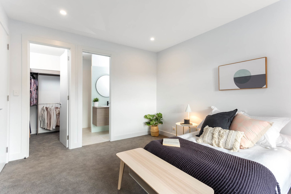 This is an example of a mid-sized contemporary guest bedroom in Adelaide with white walls, carpet and grey floor.