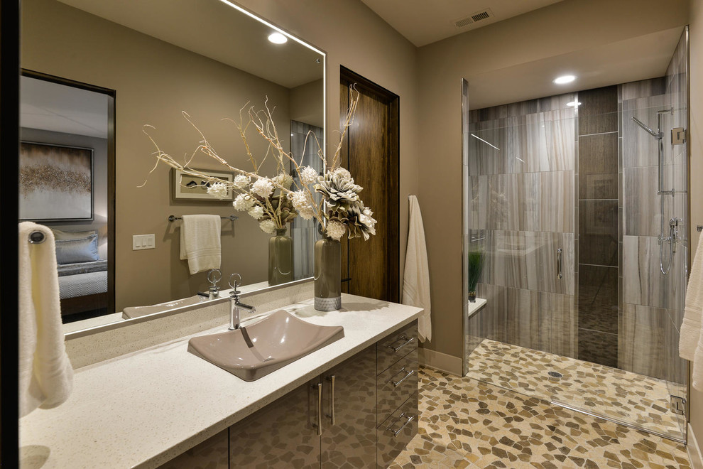 Photo of a mid-sized contemporary 3/4 bathroom in Denver with flat-panel cabinets, brown cabinets, an alcove shower, beige tile, brown tile, gray tile, porcelain tile, beige walls, mosaic tile floors, a vessel sink, engineered quartz benchtops, multi-coloured floor and a hinged shower door.