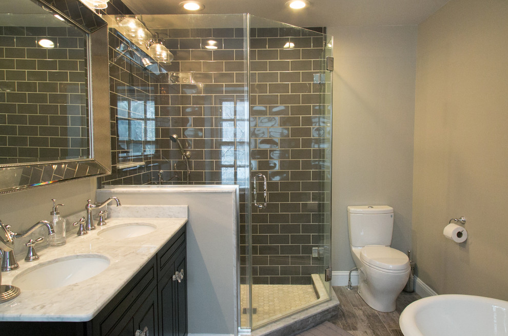 Photo of a small eclectic master bathroom in Philadelphia with an undermount sink, furniture-like cabinets, black cabinets, marble benchtops, a corner shower, a one-piece toilet, black tile, subway tile, grey walls and porcelain floors.