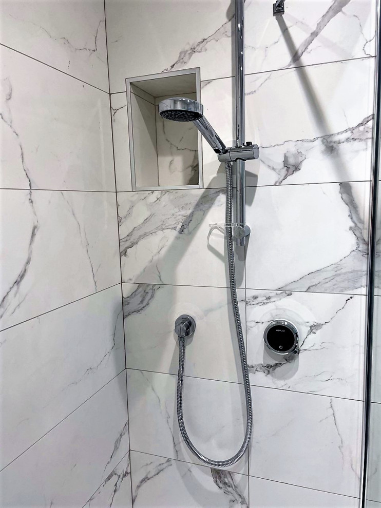 Example of a mid-sized minimalist master white tile and porcelain tile porcelain tile, multicolored floor and single-sink bathroom design in Other with flat-panel cabinets, blue cabinets, a wall-mount toilet, a vessel sink, laminate countertops, white countertops, a niche and a floating vanity