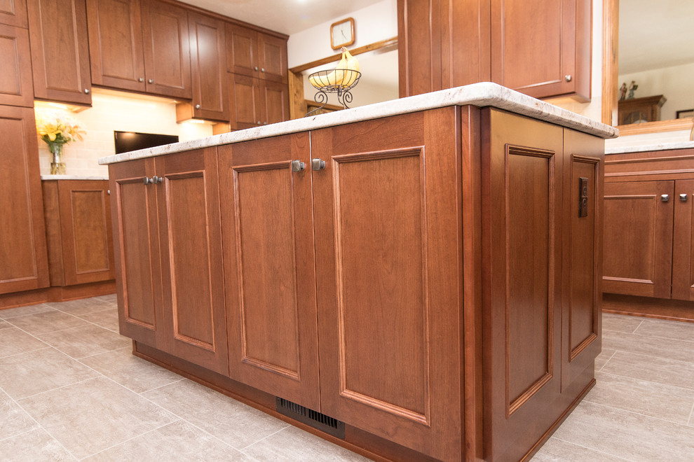 Large elegant l-shaped vinyl floor and beige floor eat-in kitchen photo in Baltimore with an undermount sink, shaker cabinets, medium tone wood cabinets, granite countertops, beige backsplash, ceramic backsplash, stainless steel appliances, an island and white countertops